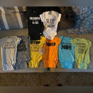 3-6 month onsies with printed messages on front.